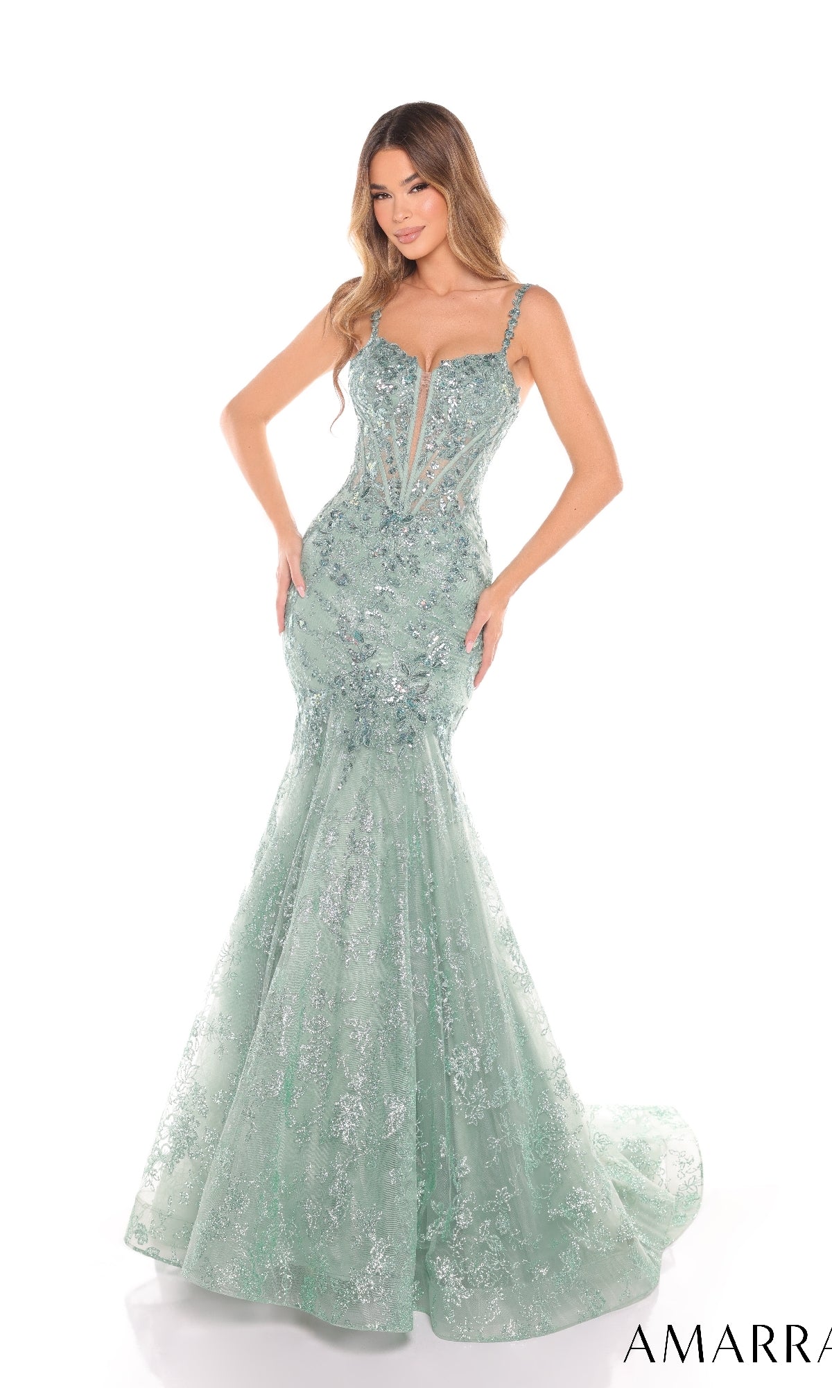 A woman poses against a white background wearing the Amarra 88373 long prom dress, featuring a fitted mermaid silhouette, light green sequins, a deep V-neckline, thin straps, and delicate floral lace accents.